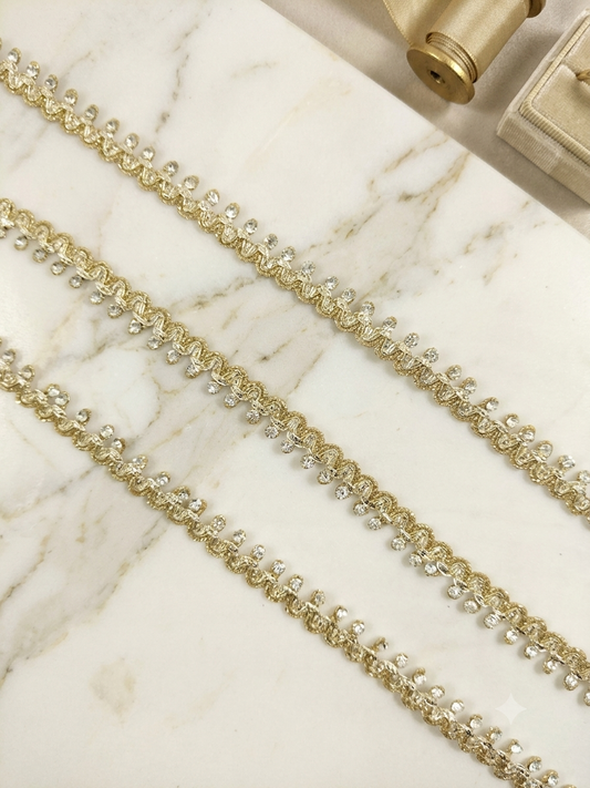 Metallic gold (double shaded) lace trim with rhinestones.